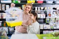 Kid girl begging her mother to buy bird cage Royalty Free Stock Photo