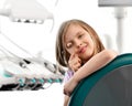 Closeup. Kid girl plays with dental mirror in dentist office