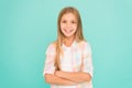 Kid girl blonde hair posing confidently. Girl feels confident with crossed arms. Child hold hands confidently crossed