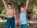 Kid girl and boy showing V gest outdoor