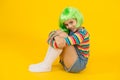 Kid girl with bright vibrant hairstyle. Artificial wig concept. Semi permanent color cream. Colored clip in hair Royalty Free Stock Photo