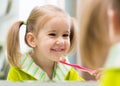 Kid girl brushing teeth in bathroom Royalty Free Stock Photo