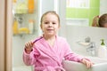 Kid girl brushing teeth in bathroom Royalty Free Stock Photo