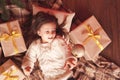 Kid girl with christmas presents under chrismas tree