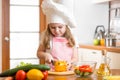 Kid girl cook cutting vegetables Royalty Free Stock Photo