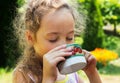 Kid girl drinking water from cup