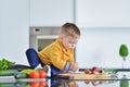 Kid girl eating healthy vegetables at kitchen Royalty Free Stock Photo