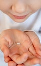 Kid girl with fallen milk tooth in hand. Royalty Free Stock Photo