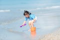 Kid girl have fun and playing sand and water at tropical beach. Royalty Free Stock Photo