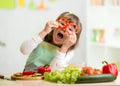 Kid girl having fun with food vegetables