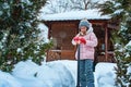 Kid girl helping to clean pathway from snow with showel. Royalty Free Stock Photo