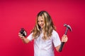 Kid girl holding hammer and alarm clock smiling with a happy and cool smile on face. showing teeth Royalty Free Stock Photo