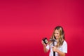 Kid girl holding hammer and alarm clock smiling with a happy and cool smile on face. showing teeth. Royalty Free Stock Photo