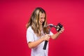 Kid girl holding hammer and alarm clock smiling with a happy and cool smile on face. showing teeth. Royalty Free Stock Photo