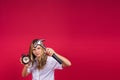 Kid girl holding hammer and alarm clock smiling with a happy and cool smile on face. showing teeth. Royalty Free Stock Photo