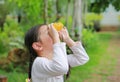 Kid girl kid looking ahead with binoculars in nature fields. Explore and adventure concept