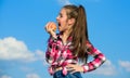 Kid girl with long hair eat apple blue sky background. Healthy nutrition concept. Child eat ripe apple fall harvest