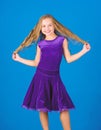 Kid girl with long hair wear dress on blue background. Hairstyle for dancer. How to make tidy hairstyle for kid. Things