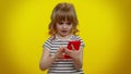 Kid girl looking smartphone display, browsing, receiving message with good news, success luck