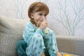 Kid girl makes inhalation with a nebulizer. sick child holding inhalator in hand and breathes through an inhaler at home