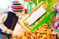 Kid girl in medical mask, gloves buys fruit