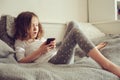 Kid girl playing smartphone at home Royalty Free Stock Photo