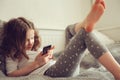 Kid girl playing smartphone at home Royalty Free Stock Photo