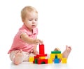 Kid girl playing toy blocks and building tower