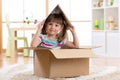 Kid girl playing in a toy house in children room Royalty Free Stock Photo