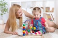 Kid girl plays with educational toy indoor. Happy Royalty Free Stock Photo