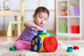 Kid girl plays with educational toy indoor Royalty Free Stock Photo