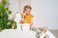 kid girl prepares dough in submersible mixer, tries and it tastes unpalatable