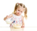 Kid girl preparing corn flakes with milk Royalty Free Stock Photo