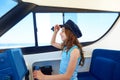 Kid girl pretending be a captain sailor cap in boat Royalty Free Stock Photo