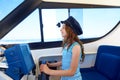 Kid girl pretending be a captain sailor cap in boat Royalty Free Stock Photo