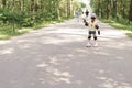 Kid girl in protective sportswear. little girl learning to roller skate.