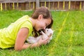 Kid girl and puppy dog happy lying in lawn Royalty Free Stock Photo