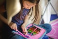 Kid girl putting colour pencils back in a pencil case Royalty Free Stock Photo