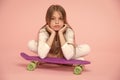 Kid girl relax lean penny board. Modern youth hobby. Active leisure concept. Girl lean on penny board pink background