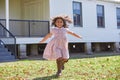 Kid girl running in park with flowers dress