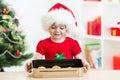 Kid girl in Santa hat holding Christmas cookies Royalty Free Stock Photo