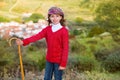 Kid girl shepherdess with wooden baston in Spain village