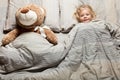 Kid girl sleep on pillow with teddy bear, bedtime. Comfort night rest