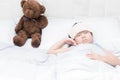 Kid girl sleeping and sick on the bed with cooler handkerchief Royalty Free Stock Photo