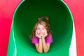 Kid girl smiling in the park playground relaxed