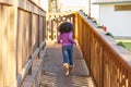 Kid girl toddler playing running in park rear view Royalty Free Stock Photo