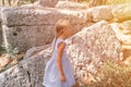 Kid girl traveler of eight years old travel and explore the ancient excavations of ruins of the ancient Lycian city of Phaselis in