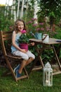 Kid girl walking with candle holder in romantic evening garden Royalty Free Stock Photo