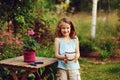 Kid girl walking with candle holder in romantic evening garden Royalty Free Stock Photo