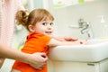 Kid girl washing hands with mom help Royalty Free Stock Photo